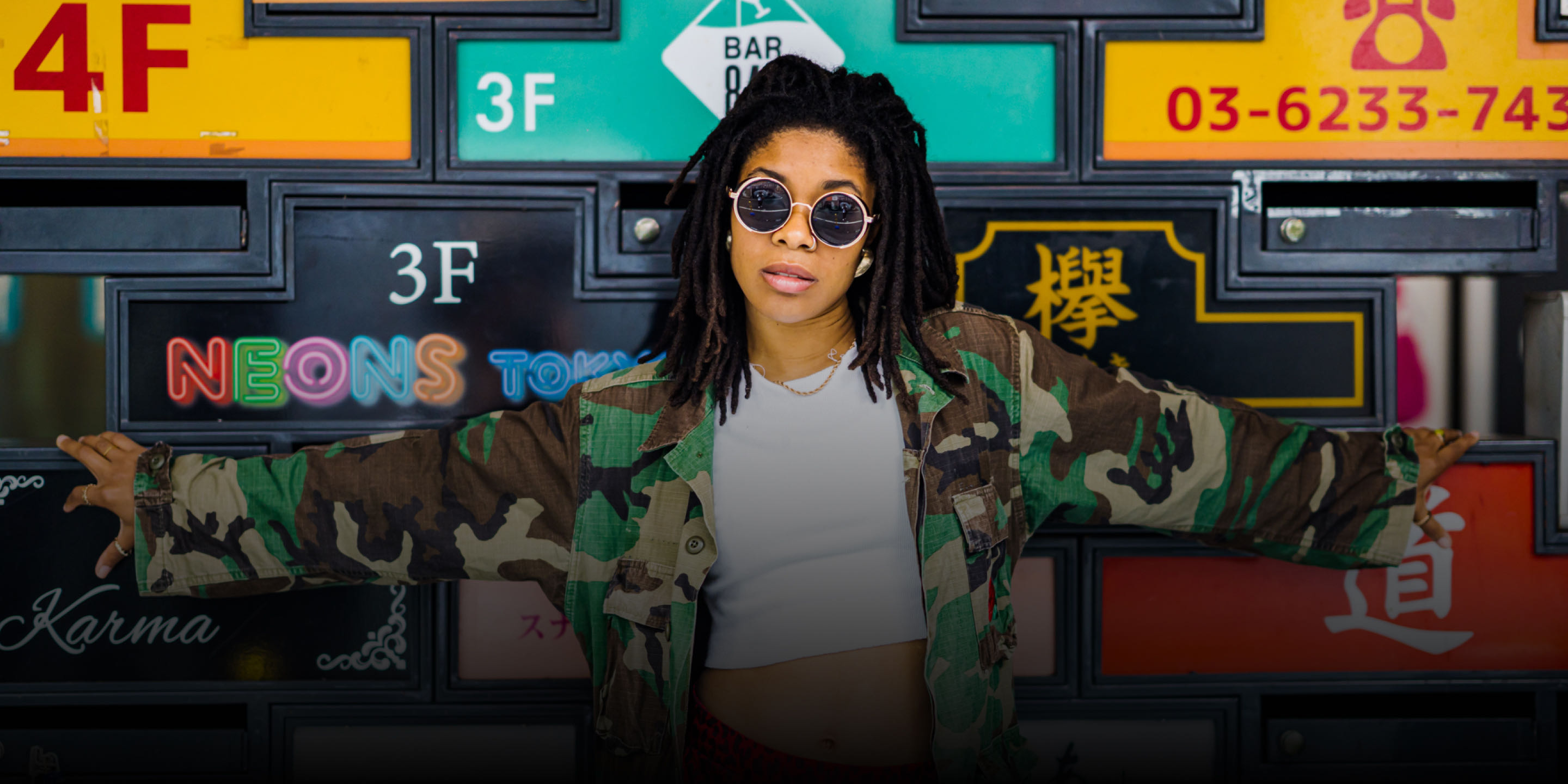 Afrodyty in front of neon city signs